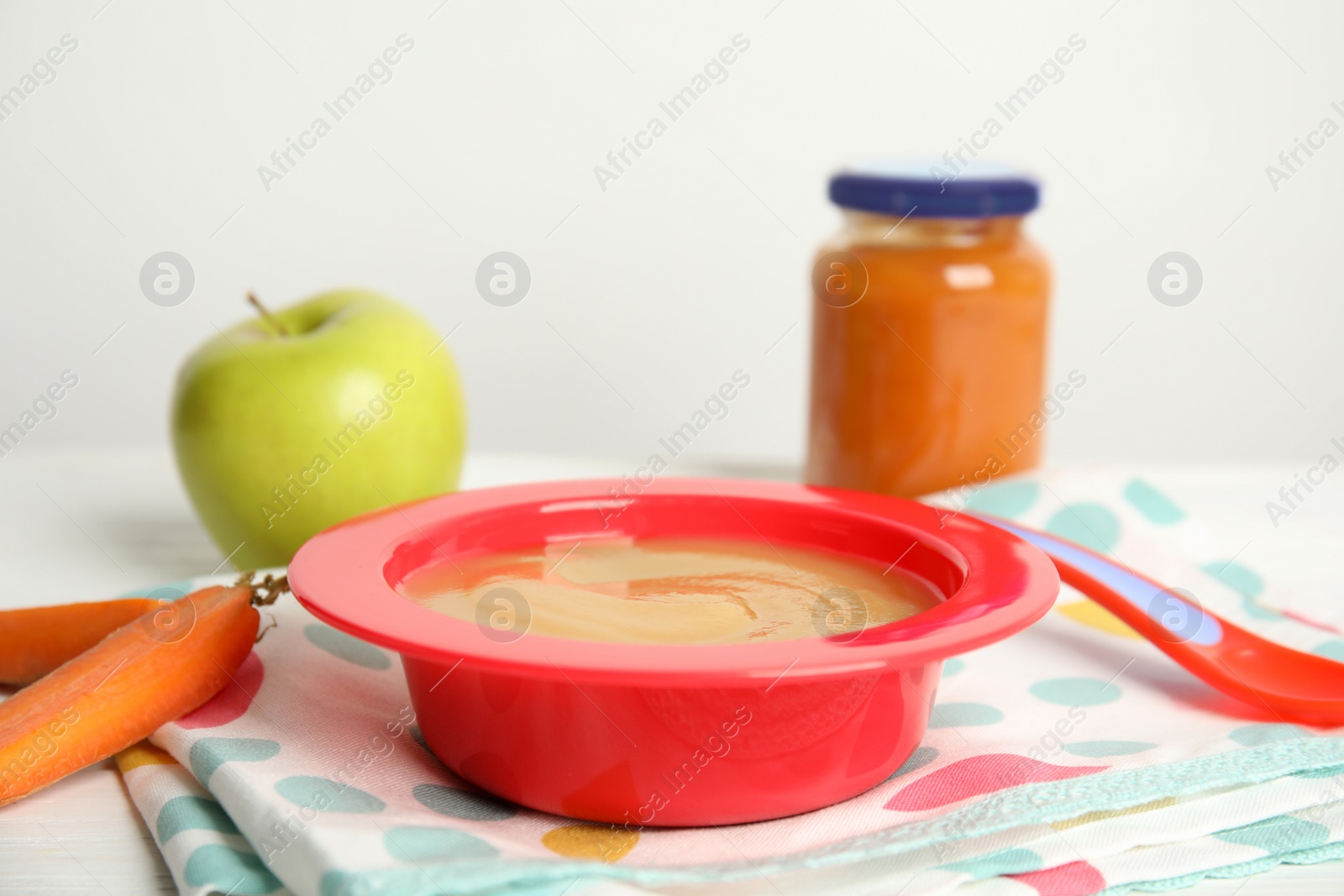 Photo of Healthy baby food and carrot on napkin