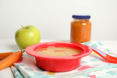 Healthy baby food and carrot on napkin