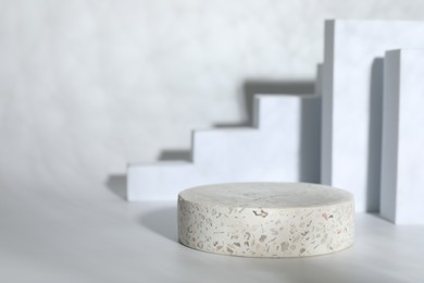 Photo of Stylish presentation of product. Stone podium on white background, space for text