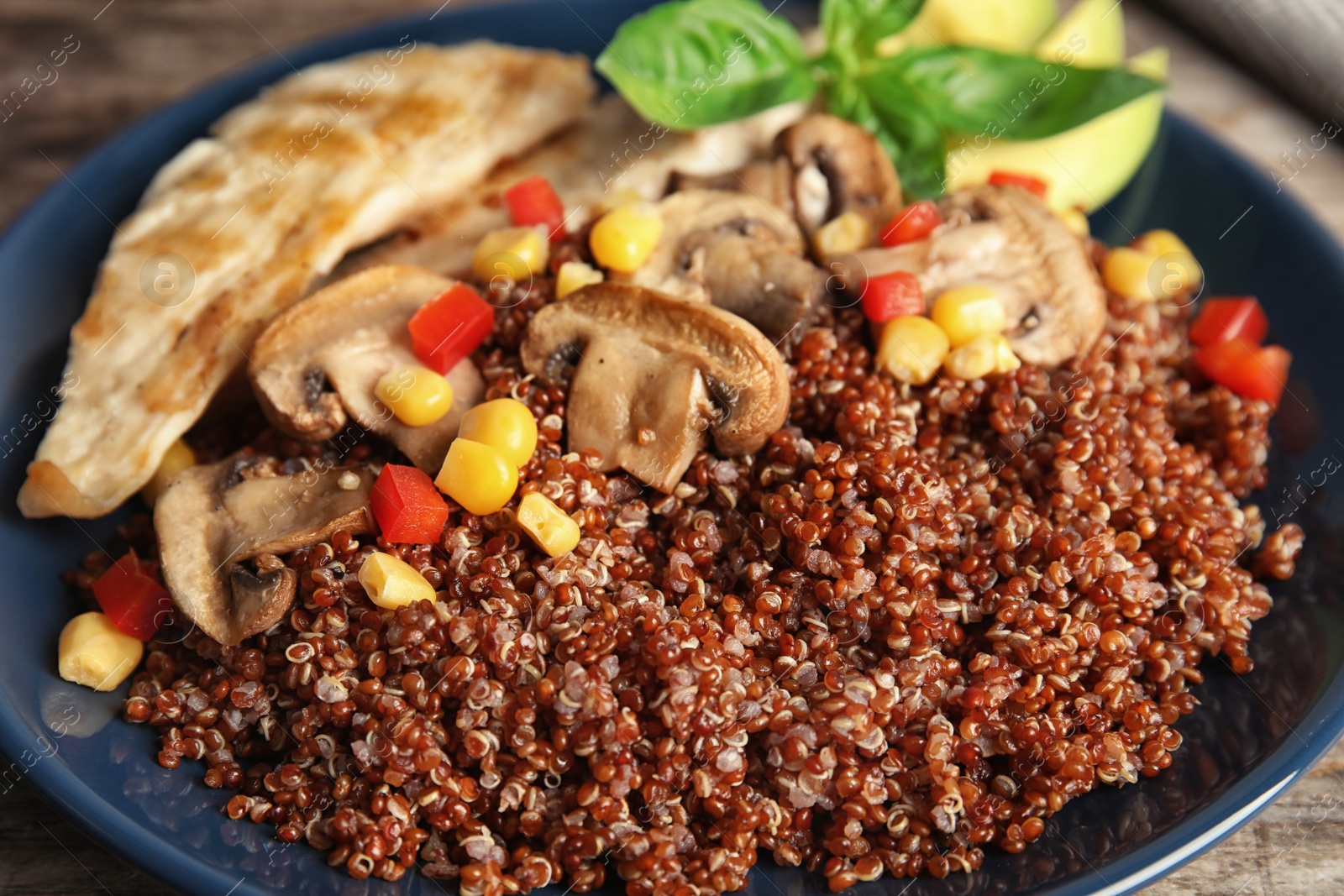 Photo of Plate with quinoa and garnish on table, closeup