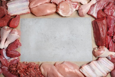 Photo of Flat lay composition with fresh raw meat and space for text on gray background