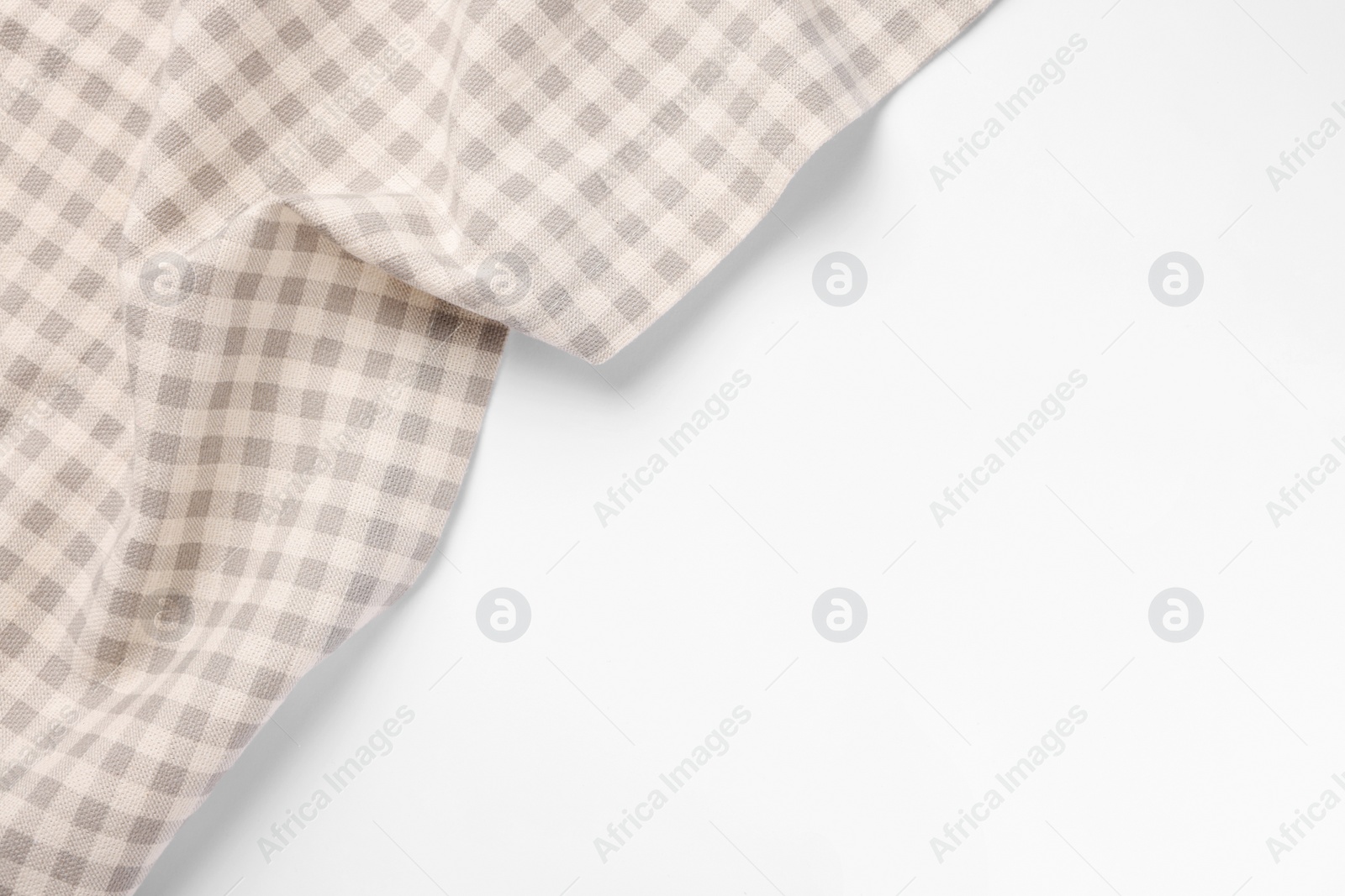 Photo of Beige checkered tablecloth on white background, top view