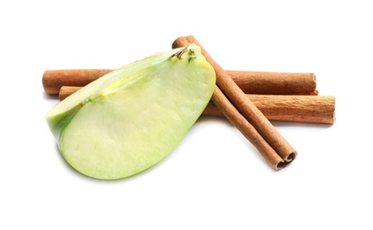 Slice of fresh apple and cinnamon sticks on white background