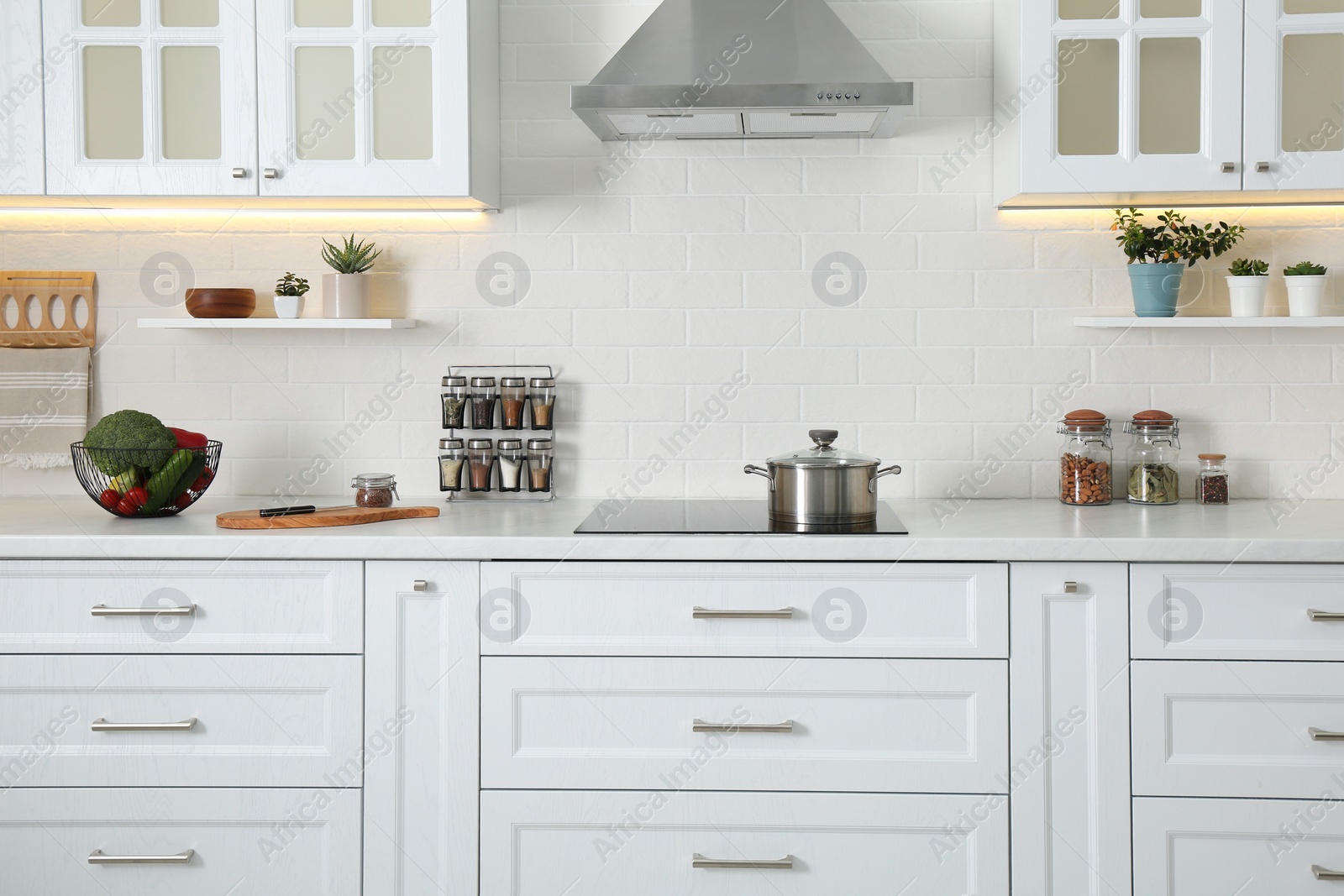 Photo of Elegant kitchen interior with modern stove and stylish furniture