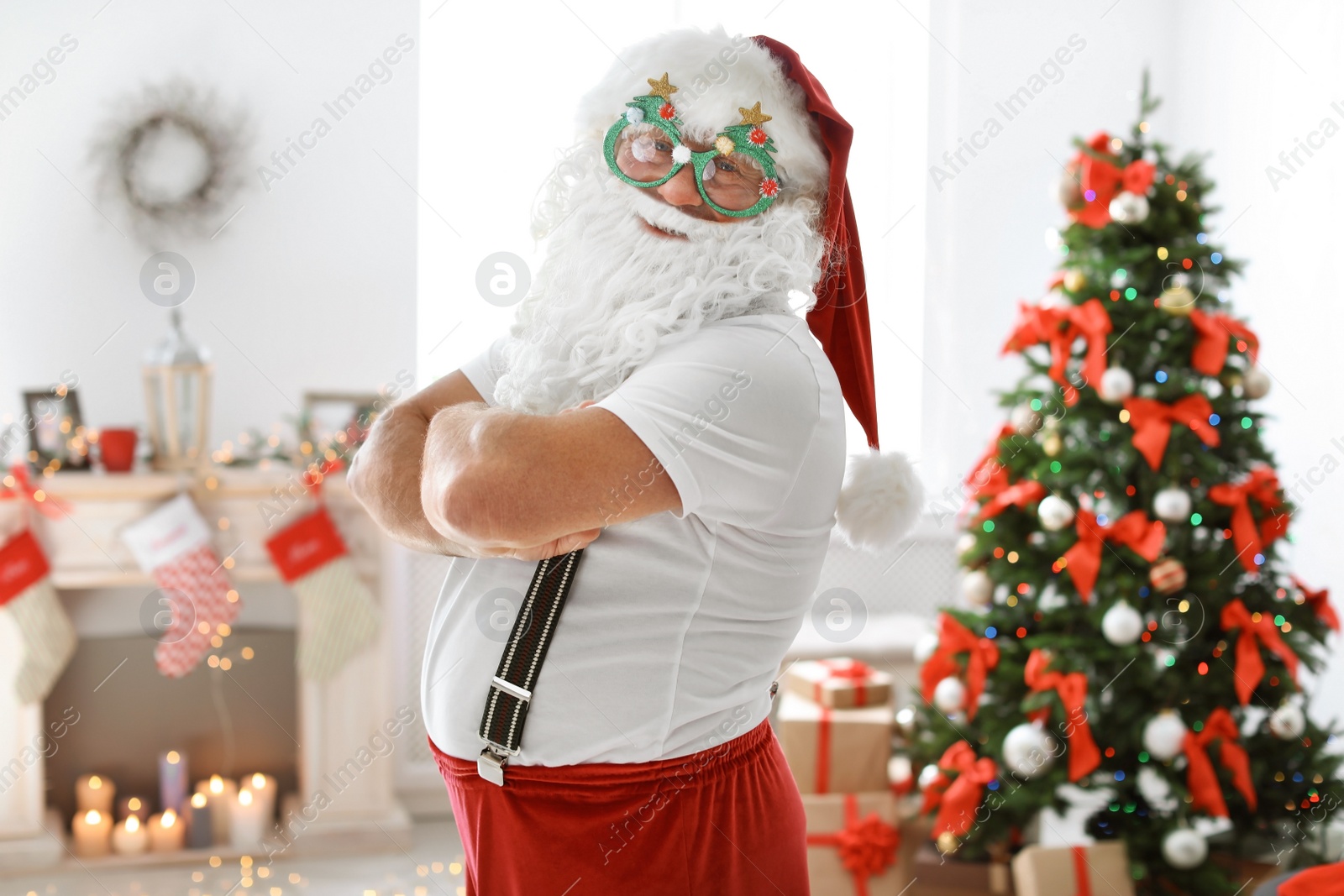 Photo of Authentic Santa Claus with funny glasses indoors