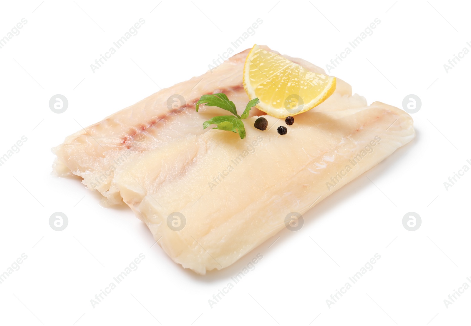 Photo of Pieces of raw cod fish, parsley, peppercorns and lemon isolated on white