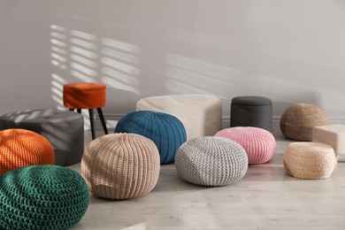 Many stylish different poufs indoors. Home design