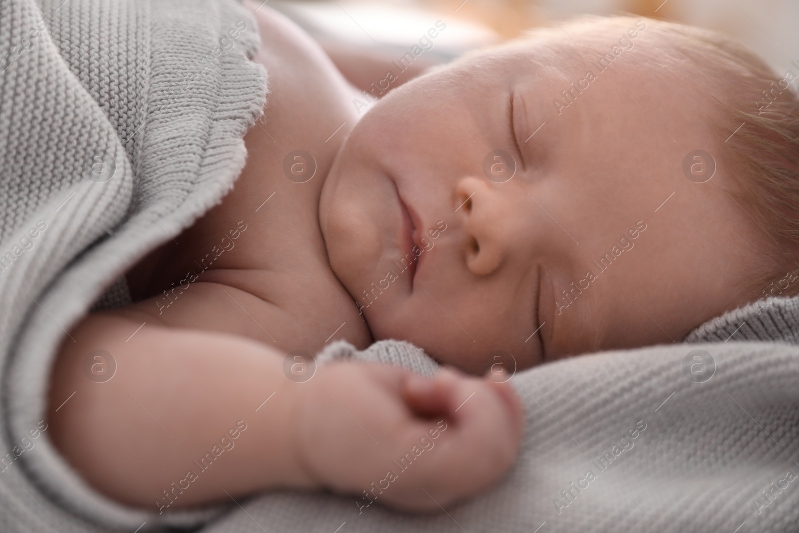 Photo of Cute little baby sleeping on bed, closeup