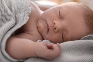 Photo of Cute little baby sleeping on bed, closeup