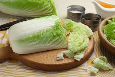 Photo of Cut fresh Chinese cabbage, oil and spices on table