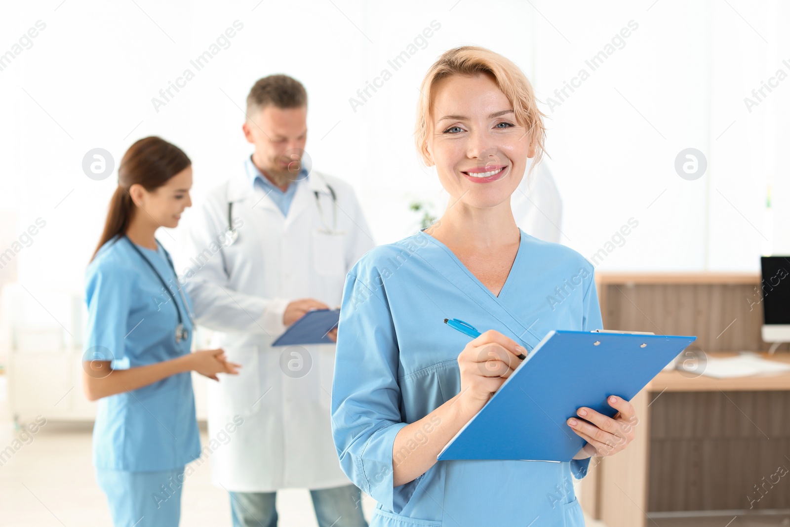 Photo of Medical assistant with colleagues in clinic. Health care service