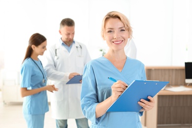 Medical assistant with colleagues in clinic. Health care service