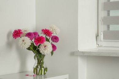 Photo of Bouquet of beautiful Dahlia flowers in vase indoors