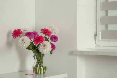 Bouquet of beautiful Dahlia flowers in vase indoors