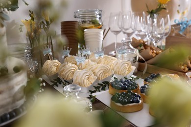 Photo of Tasty treats on table in room. Sweet buffet