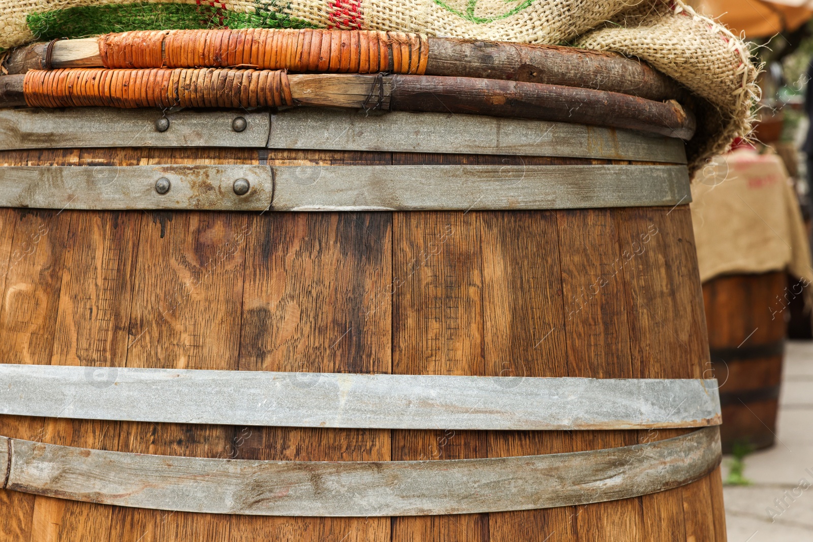 Photo of Traditional wooden barrel outdoors, closeup. Wine making