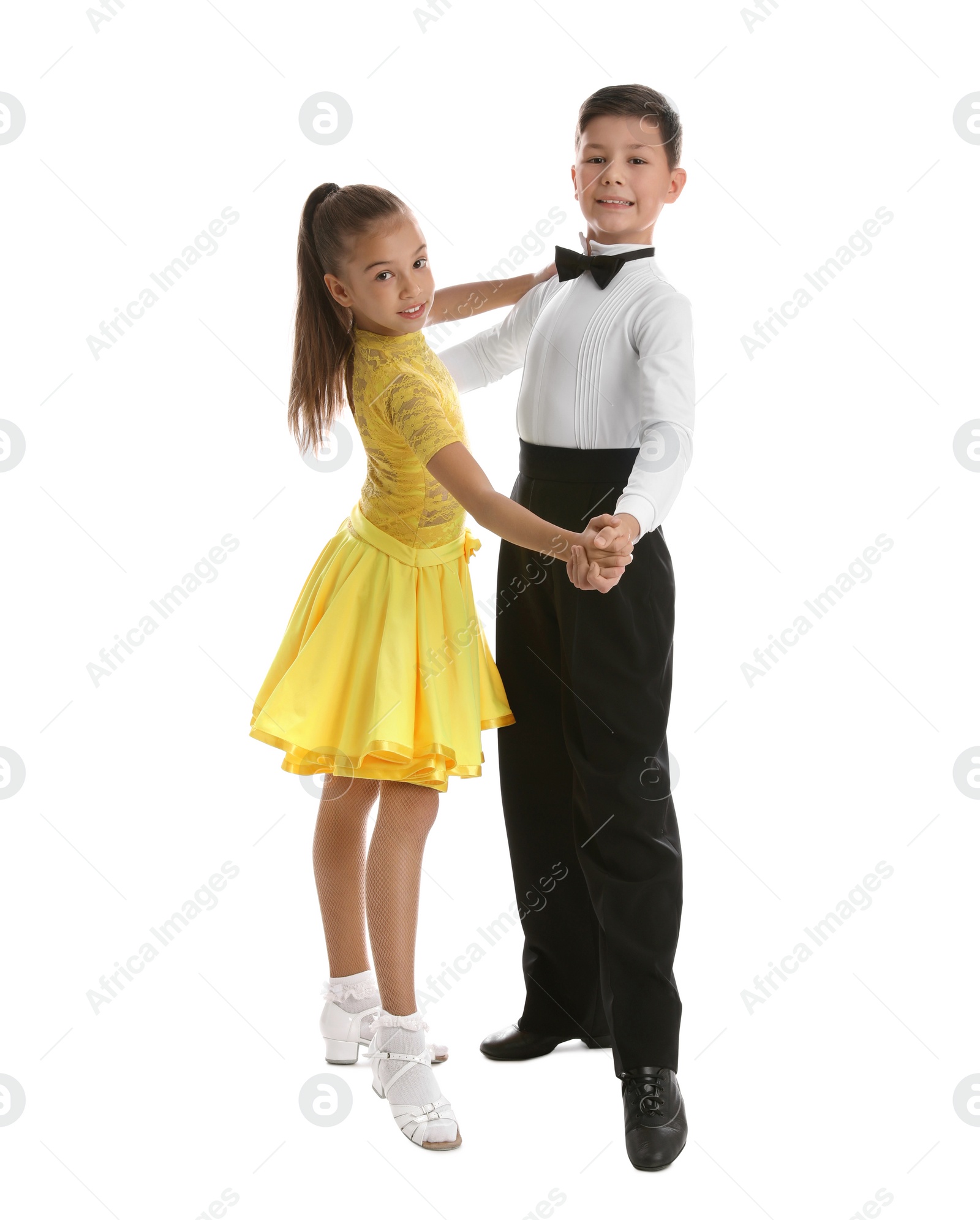 Photo of Beautifully dressed couple of kids dancing on white background