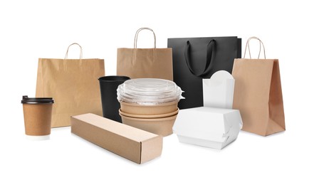 Set with different paper bags, containers for food and takeaway cups on white background