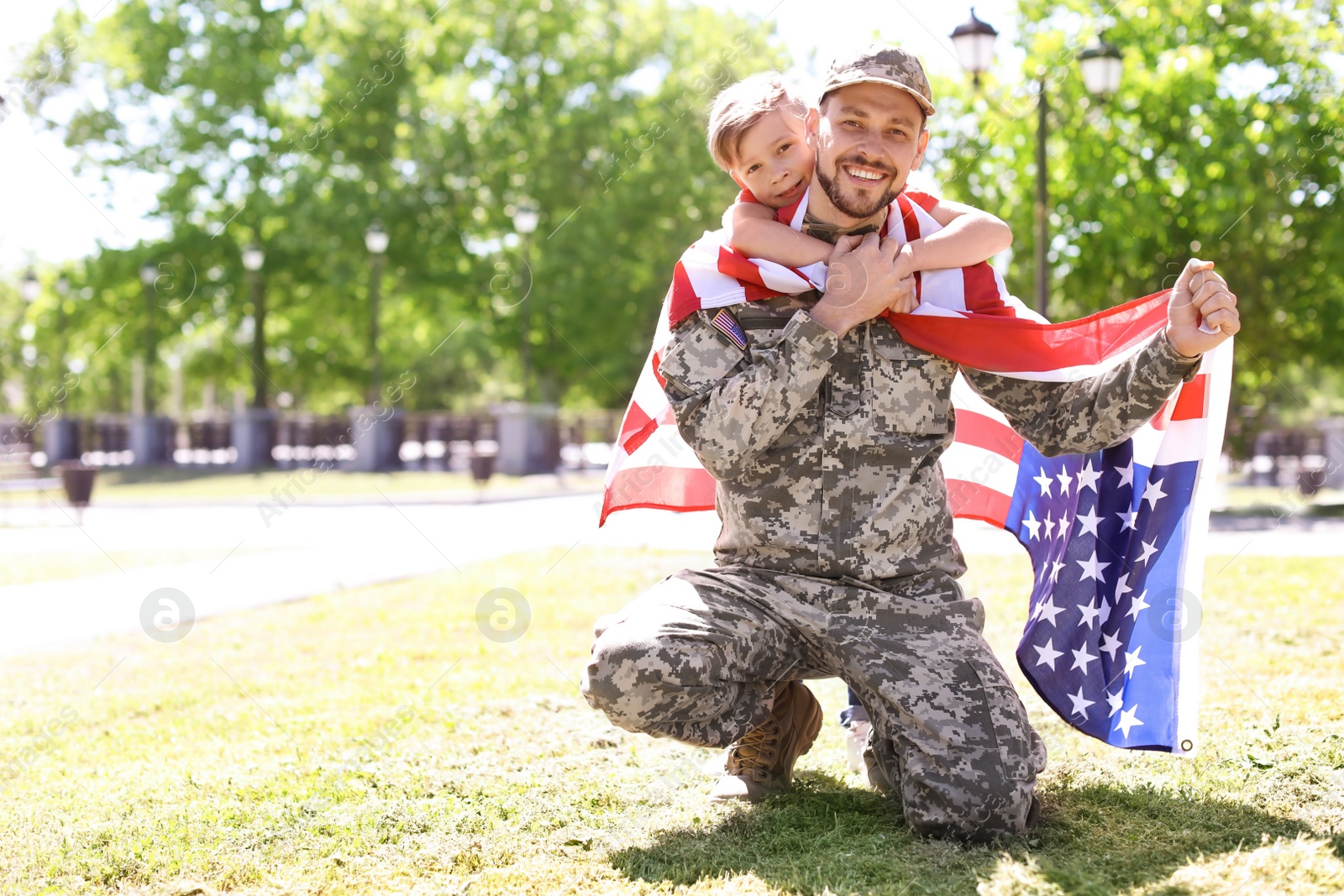 Photo of American soldier with his son outdoors. Military service