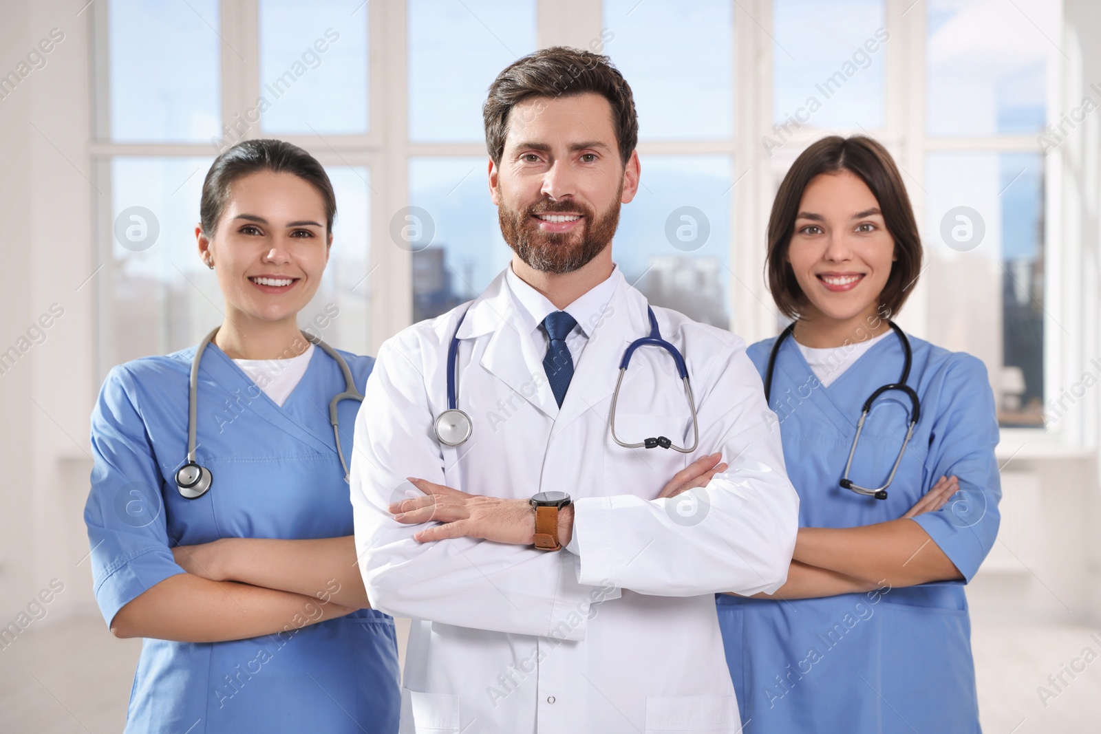 Photo of Team of professional doctors in clinic hallway