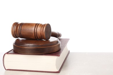 Photo of Wooden gavel, sound block and book on light table against white background. Space for text