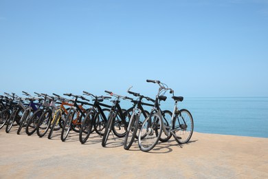 Photo of Parking with bicycles on embankment near sea