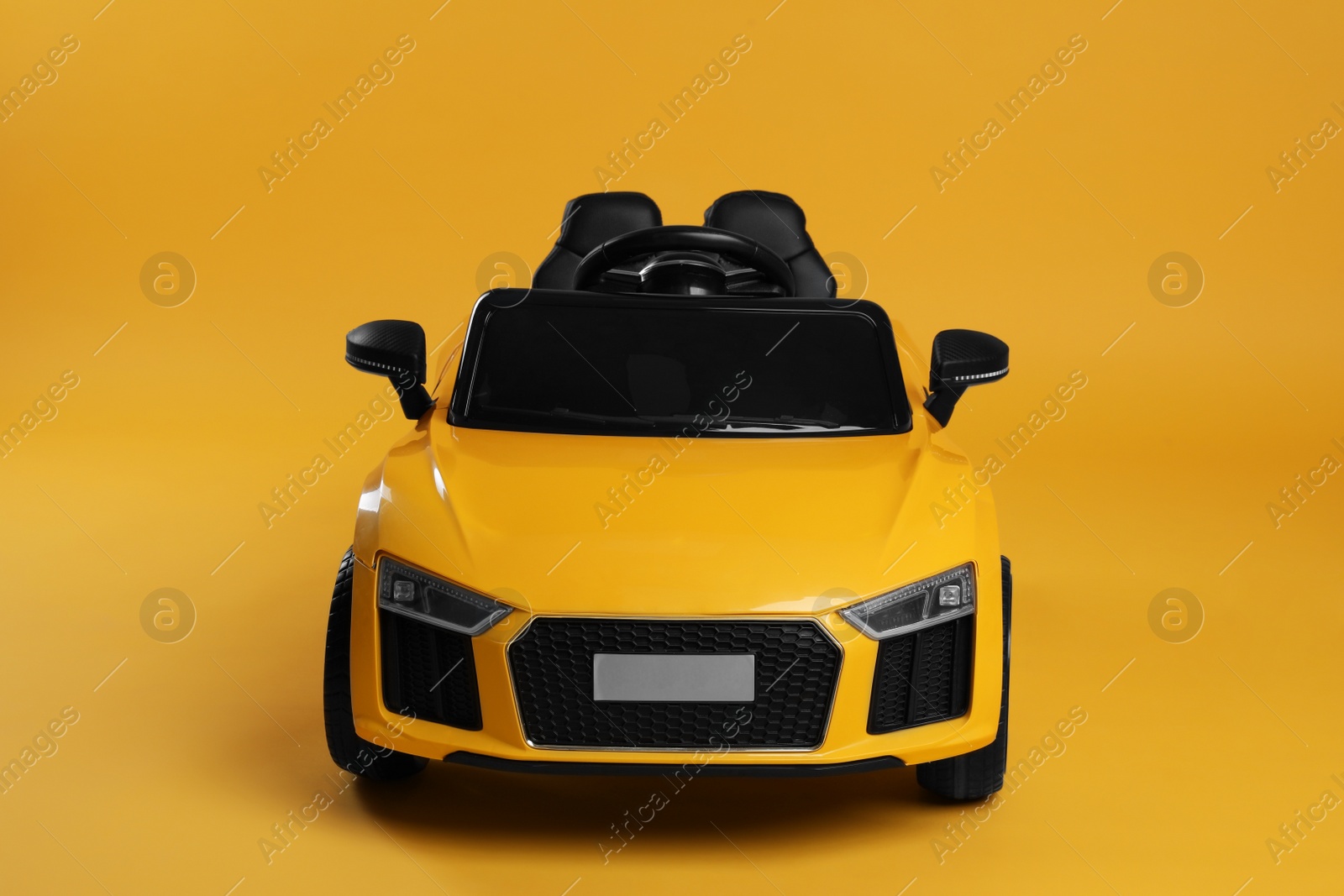 Photo of Child's electric toy car on yellow background