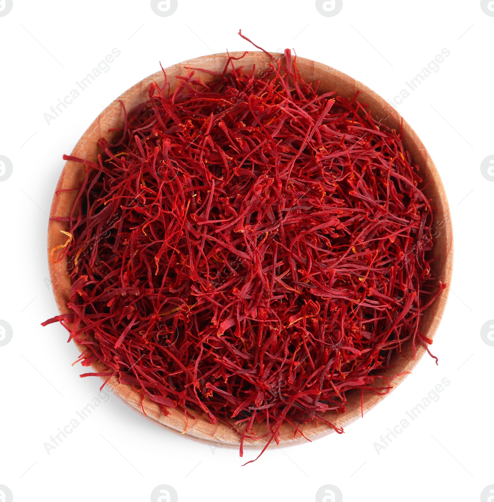 Photo of Dried saffron in wooden bowl isolated on white, top view