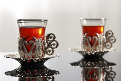 Glasses with traditional Turkish tea on table indoors, space for text