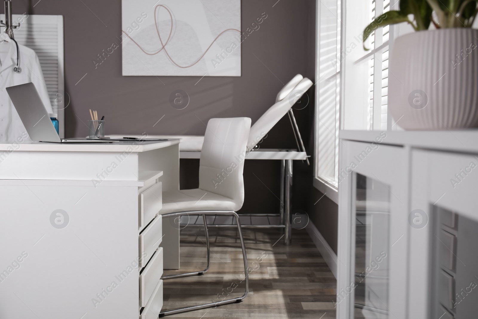 Photo of Modern medical office interior with doctor's workplace