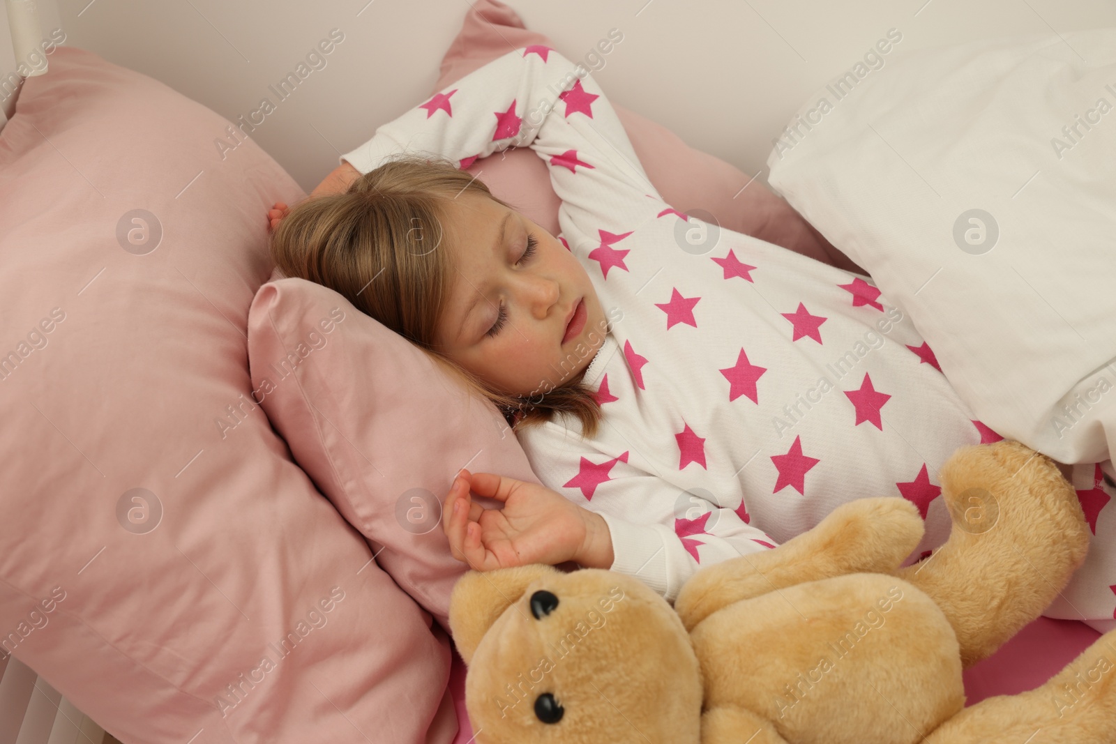 Photo of Little girl snoring while sleeping in bed