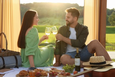 Romantic date. Beautiful couple having picnic outdoors on sunny day