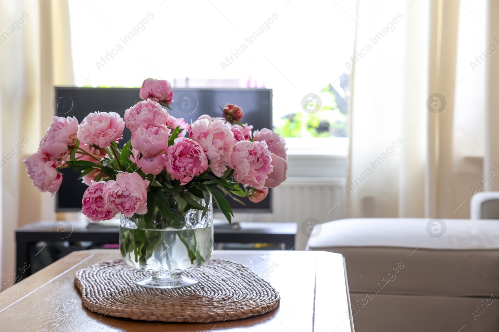 Photo of Beautiful pink peonies in vase on table at home, space for text. Interior design