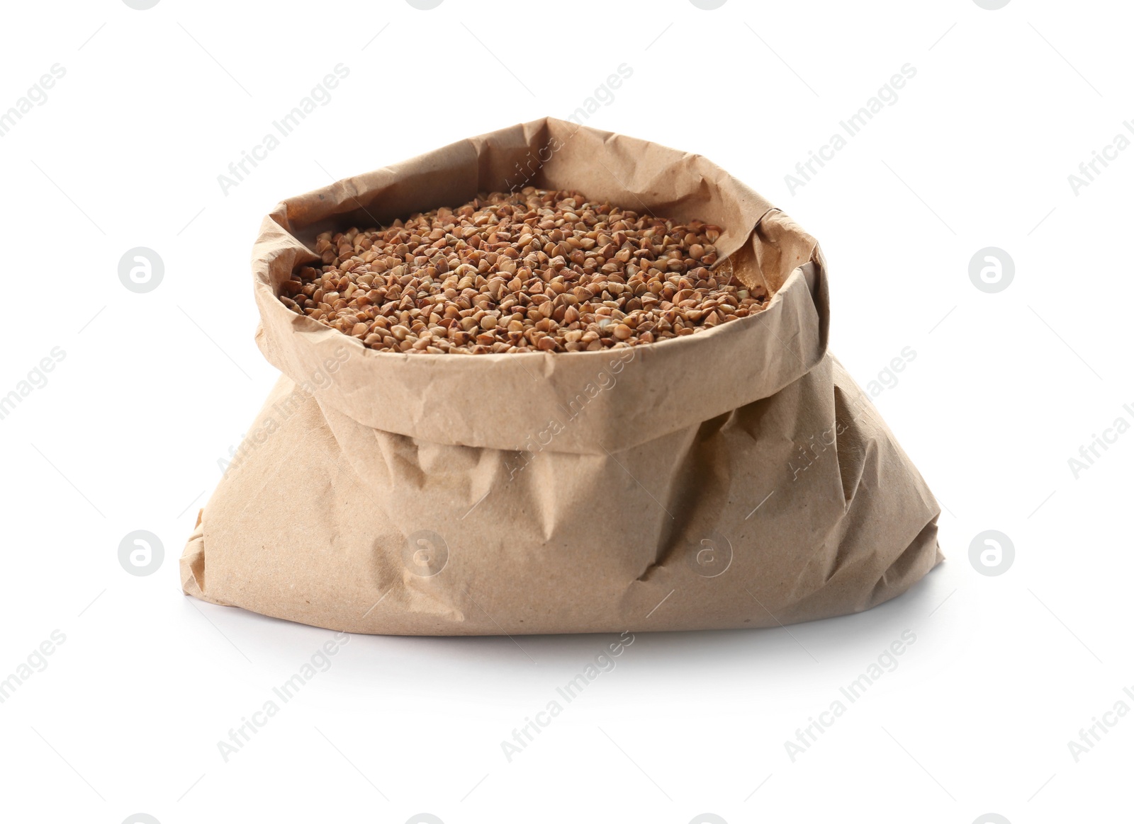 Photo of Paper bag with raw buckwheat on white background. Healthy grains and cereals