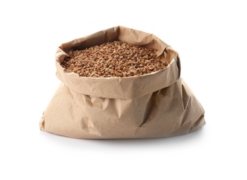 Paper bag with raw buckwheat on white background. Healthy grains and cereals