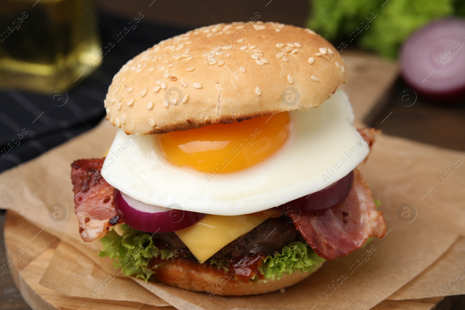 Photo of Delicious burger with fried egg on table, closeup