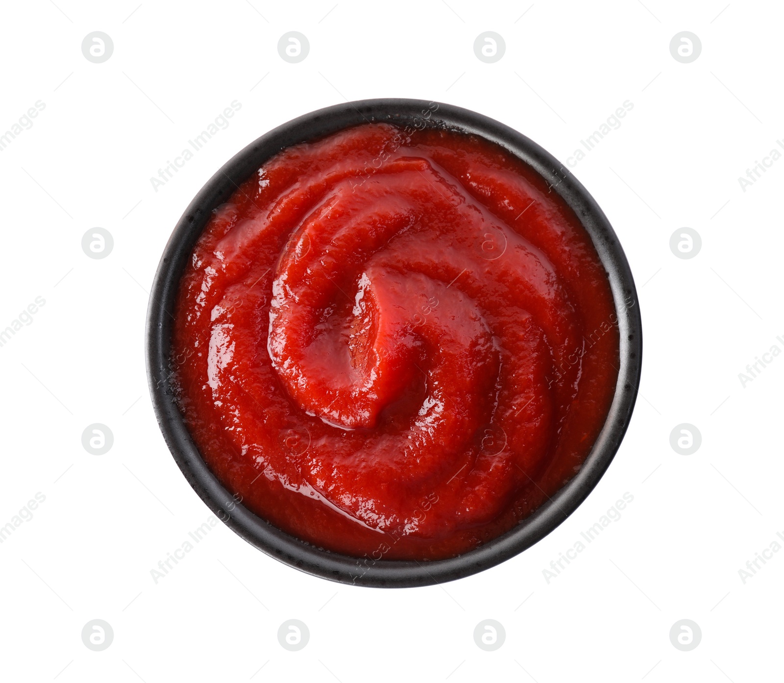 Photo of Tasty ketchup in bowl isolated on white, top view