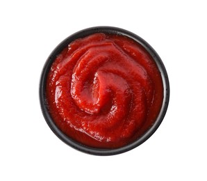 Photo of Tasty ketchup in bowl isolated on white, top view