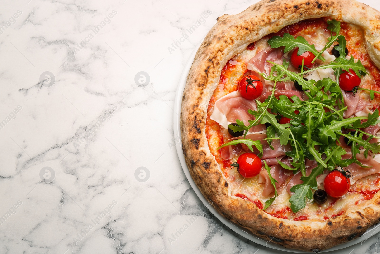 Photo of Tasty pizza with meat and arugula on white marble table, top view. Space for text