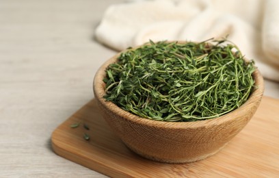 Photo of Aromatic thyme in bowl on white wooden table