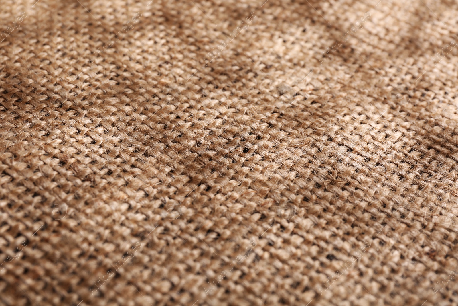 Photo of Texture of beige burlap fabric, closeup view