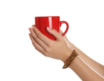 Woman holding elegant red cup on white background, closeup