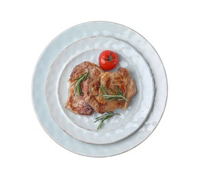 Photo of Plate of delicious fried meat with rosemary and tomato isolated on white, top view