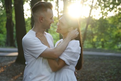 Happy young couple having good time together in park