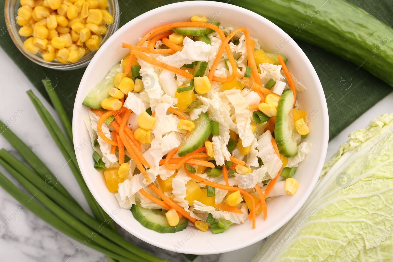 Photo of Tasty salad with Chinese cabbage served on white marble table, top view