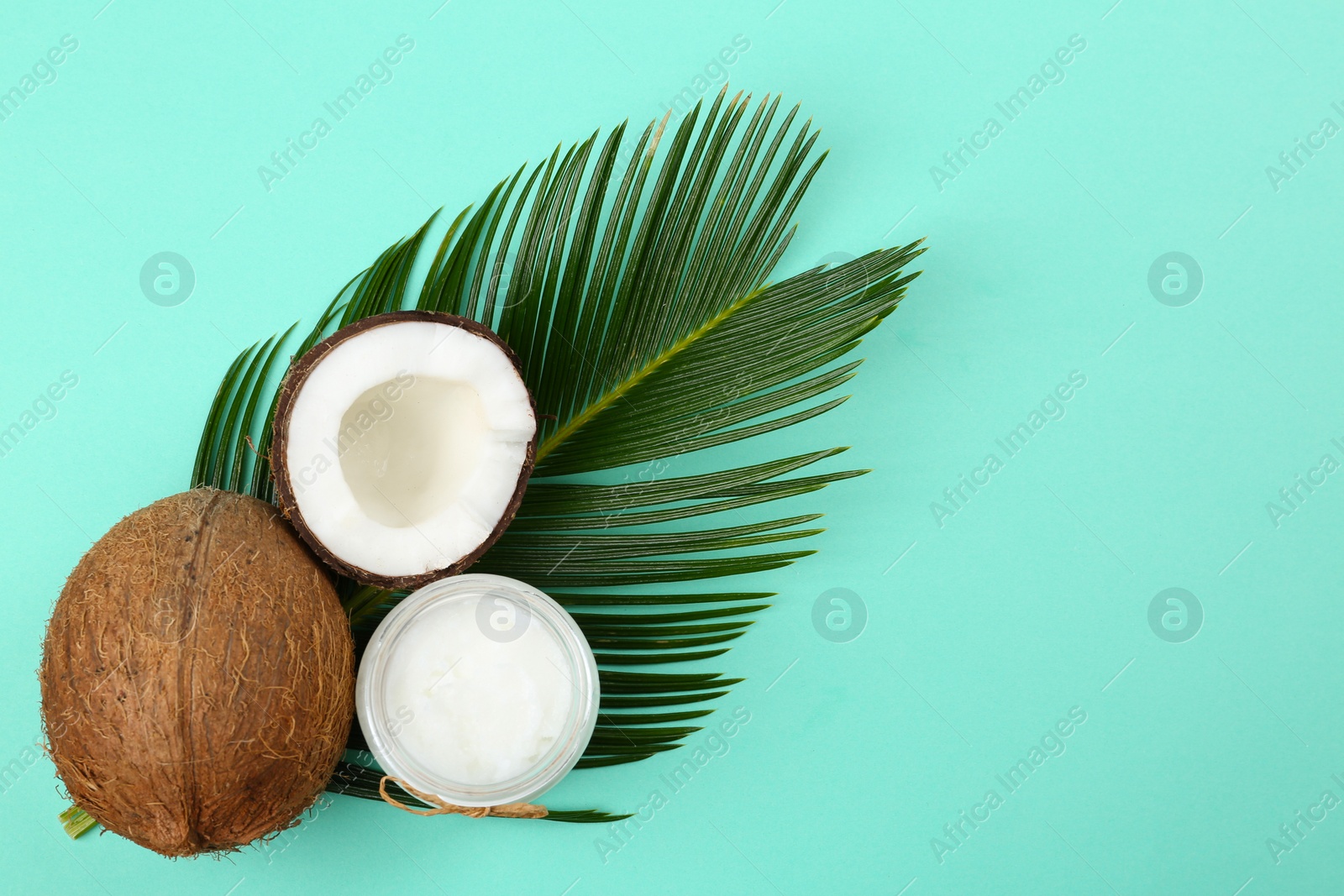 Photo of Flat lay composition with organic coconut oil on turquoise background. Healthy cooking