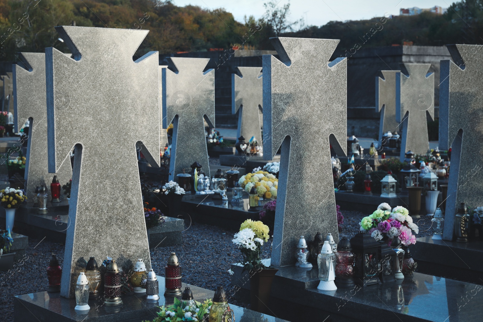 Photo of Many granite tombstones on cemetery. Funeral ceremony