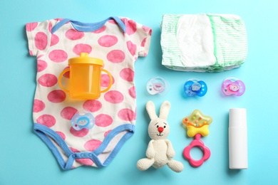 Photo of Flat lay composition with baby accessories on color background