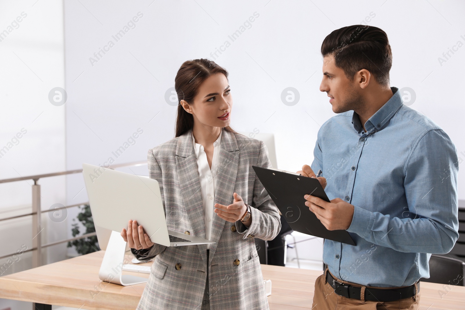 Photo of Businesswoman helping intern with work in office