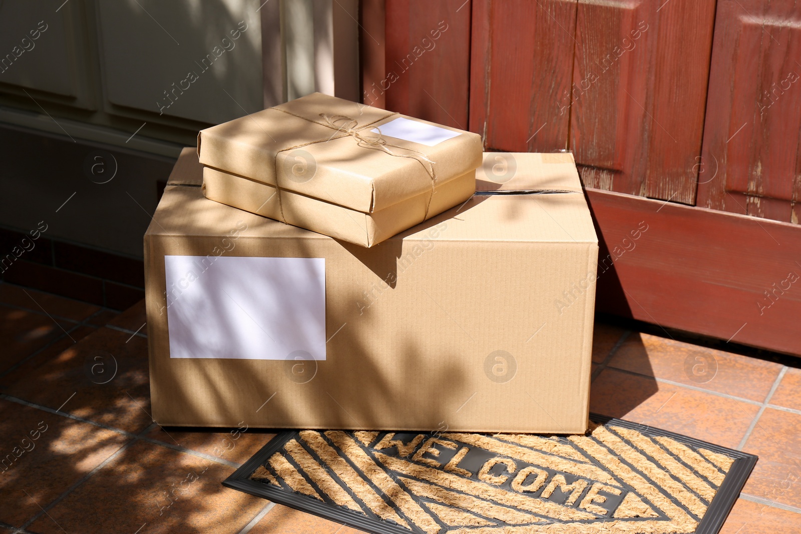 Photo of Delivered parcels on door mat near entrance